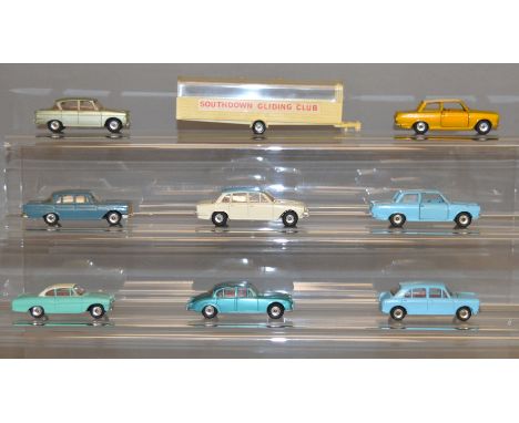 Eight unboxed Dinky Toys diecast model cars, including 145 Singer Vogue and a 135 Triumph 2000 with 'Southdown Gliding Club' 