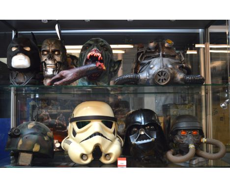 Eight assorted mask and helmets, includes: Stormtrooper; Darth Vader; Batman. Together with a model of a severed hand with an