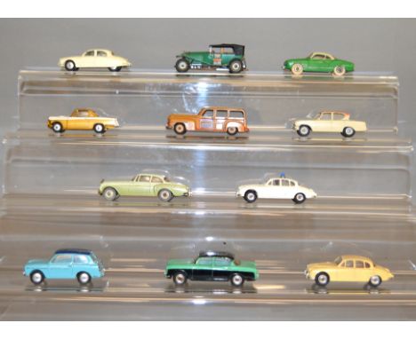 Eleven unboxed Dinky and Corgi diecast model cars including a Dinky Humber Hawk, Jaguar Saloon and Police variants and Corgi 