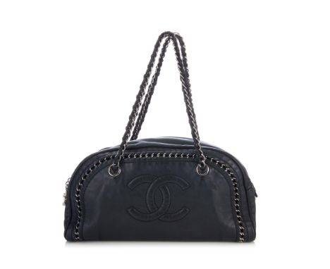 Chanel, a Luxe Ligne Bowler handbag, crafted from black leather with silver-tone chain trim, dual chain and leather handles, 