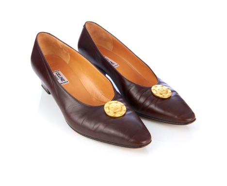 Celine, a pair of vintage court shoes, crafted from brown leather featuring maker's brushed gold-tone logo medallion to the v