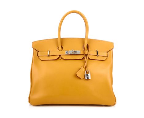 Hermes, a 2009 caramel Birkin 35 handbag, featuring a smooth Swift leather exterior, dual rolled leather handles, top flap an