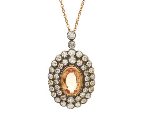 An early 20th century silver and gold, orange topaz and circular-cut diamond cluster pendant, suspended from a 9ct gold chain