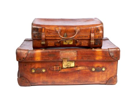 Vintage luggage, two late Victorian / early Edwardian tan leather trunks, to include a smaller 'Warranted Leather' trunk with