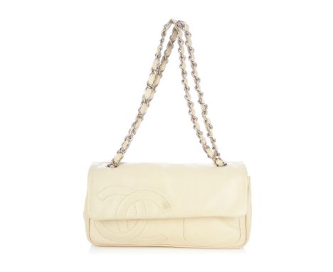 Chanel, a Diagonal CC Ligne Flap handbag, designed with an ivory lambskin leather exterior, featuring a diagonally embossed C