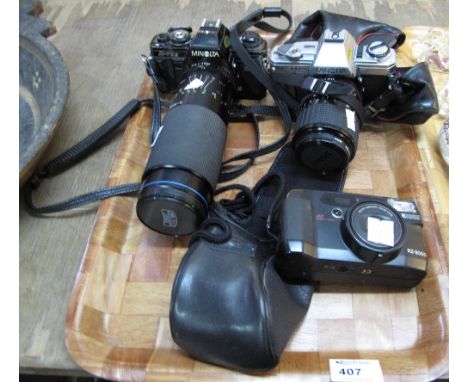 Two Minolta 35mm cameras, model numbers: X-700 and X-300, together with a Rico RZ-3000. (3)