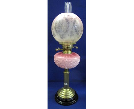Victorian brass double burner oil lamp with pink relief moulded foliate reservoir on a brass pedestal and ceramic base, havin
