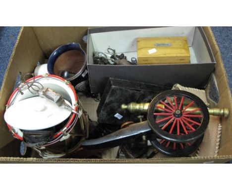 Box of assorted items to include: wooden and brass model of a canon; Welsh Guards biscuit barrel in the form of a drum; vario
