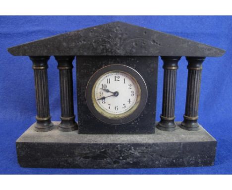Small black slate architectural mantel clock with back winding movement.