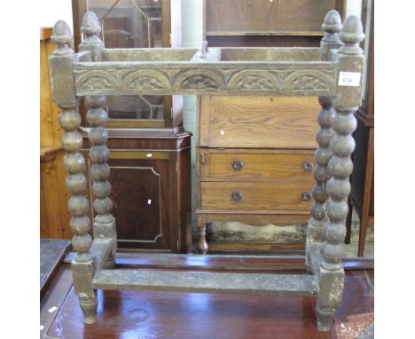 Early 20th Century oak carved umbrella stand on bobbin turned supports.