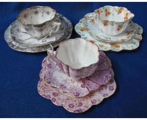 Three similar Wileman and Co./Foley China, bone china fluted design teacup, saucer and side plate trios.  Different printed m