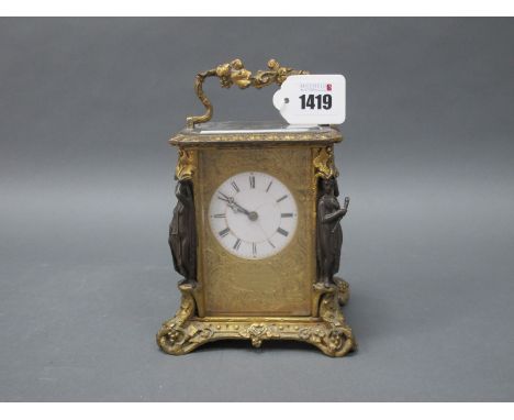 A Late XIX Century French Gilt Metal Carriage Clock, elaborately cast with vines and foliage, the corners with bronzed maiden