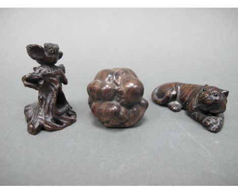A Modern Japanese Carved Wood Okimono in the form of a Crouching Man, 3.5cm high and two similar netsuke, one carved as a rec