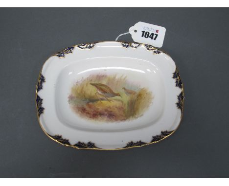 A Royal Worcester Pottery Vitreous Dish, painted by Johnson, signed, with a corncrake within a dark blue and gilt border, 17c