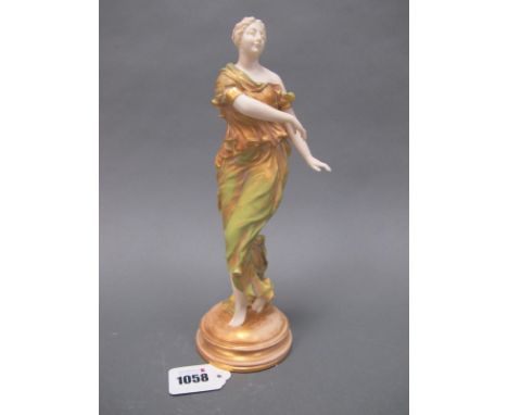 A Royal Worcester Porcelain Figure of a Dancing Lady, wearing a long flowing dress in green and gilt, raised on circular plin