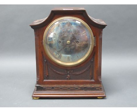 An Early XX Century Mahogany Cases Mantle Clock, the arched case with carved side columns and swags to the front, on a steppe