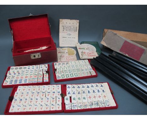 An Early XX Century Mah-Jong Set, the leatherette carrying case with lift-out trays containing bone and bamboo tiles and stic