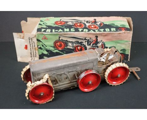 Boxed Triang Tractor Number 3 tinplate clockwork model in silver with red wheels, cream treads damaged, model showing play we