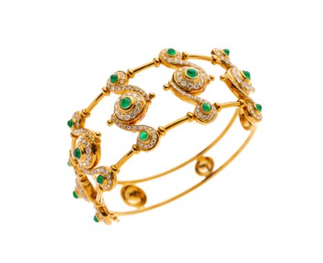 An 18ct gold emerald cabochon and brilliant-cut diamond hinged bangle, of openwork scrolling design, estimated total diamond 