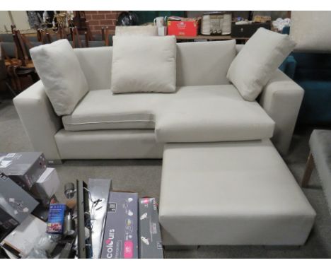 A LARGE MODERN UPHOLSTERED CREAM THREE SEATER SOFA AND LARGE STOOL (2)