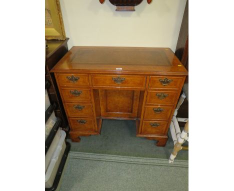 A REPRODUCTION WALNUT LEATHER TOPPED KNEEHOLE DESK H-82 W-93 CM NOTE - IN OFFICE