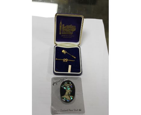 A GOLD PLATED STAFFORDSHIRE KNOT BROOCH TOGETHER WITH A STICK PIN AND A NEW ZEALAND PAUA SHELL BROOCH (3)