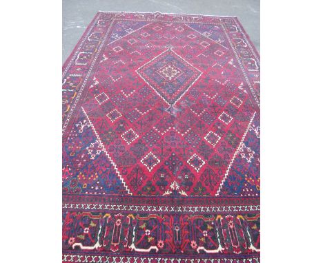 A LARGE IRANIAN CARPET - NAVY GROUND, APPROX 330 X 215 CM - WEAR THROUGHOUT