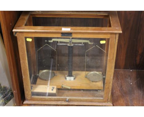 A CASED SET OF LABORATORY SCALES WITH CASED SET OF WEIGHTS
