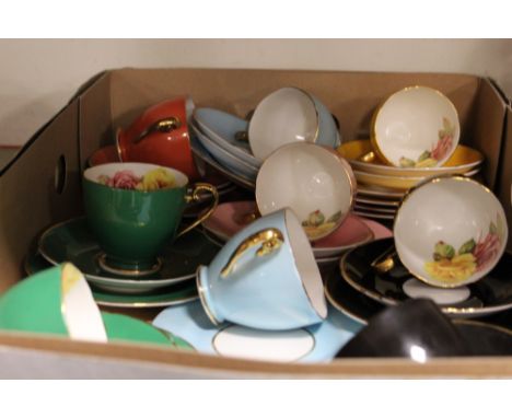 A TRAY OF ASSORTED EDWARDIAN BONE CHINA HARLEQUIN COLOURED FLORAL CUPS, SAUCERS ETC