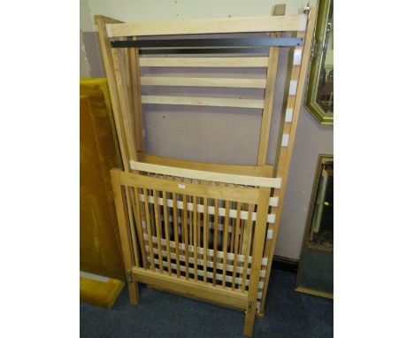 A PAIR OF MODERN 'FEATHER &amp; BLACK' OAK SINGLE BED FRAMES