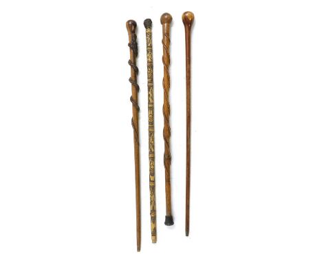 A folk art carved walking stick, carved with two entwined snakes, 83cm long, another similar example, 94cm long, a plain exam