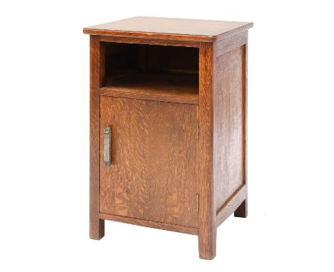 An Arts &amp; Crafts oak bedside chest, with a square top, with rounded edges, with a single shelf over a cabinet door, with 