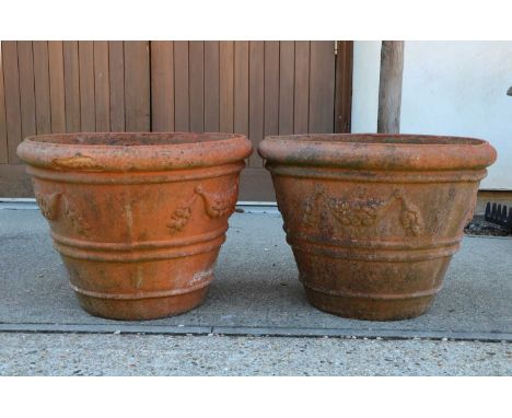 A large pair of terracotta planters of tapering cylindrical form, with relief husk detail, 61cm diameter x 46cm highCondition