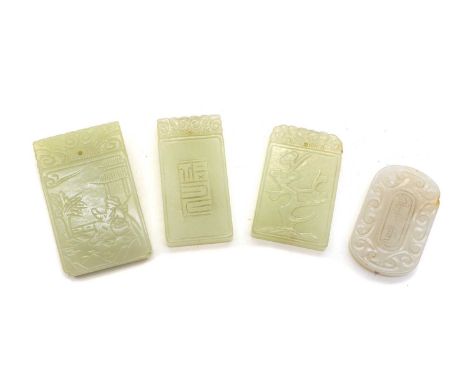Four Chinese jade pendants, one carved with a blossoming prunus tree, 4.6cm high, one of a fisherman next to a river, 5.4cm h