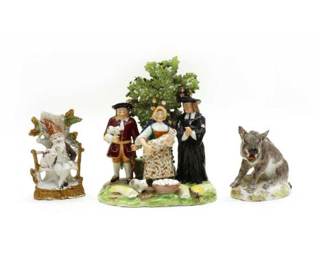 A 19th Century Chelsea Derby style ceramic figural group, depicting figures before a floral bocage, bearing gold anchor mark 