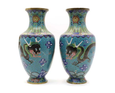 A pair of Chinese cloisonne vases, 20th century, of baluster form, decorated with dragons and peacocks amongst clouds, 32.3cm