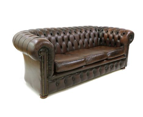 A brown leather three seater Chesterfield sofa, raised on bun feet, 200cm wide, 70cm deep, 76cm high, seat 45cm highCondition