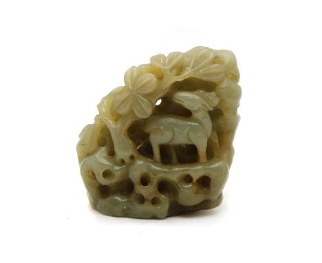 A Chinese jade carving, carved with deer on rocks beneath a tree, 7.5cm highCondition report: Russet inclusions, cracks and m