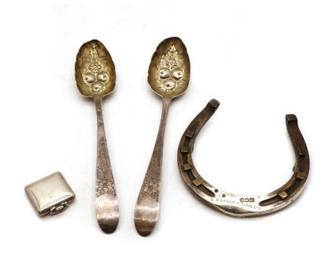 A silver horse shoe by Rosener &amp; Son, London 1920, 12cm wide, together with a pair of berry spoons, possibly Irish silver