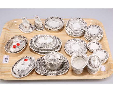 A late 19th Century English pottery child’s tea service, transfer printed in brown, comprising plates, dishes and covers, two