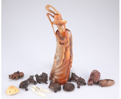 A group of seven carved wood Japanese netsuke, comprising five mythical beasts, a cicada and a chrysanthemum; together with a