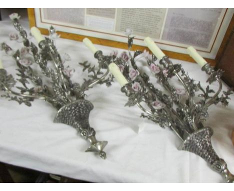 An unusual pair of silver coloured 3 branch wall lights decorated with ceramic flowers.