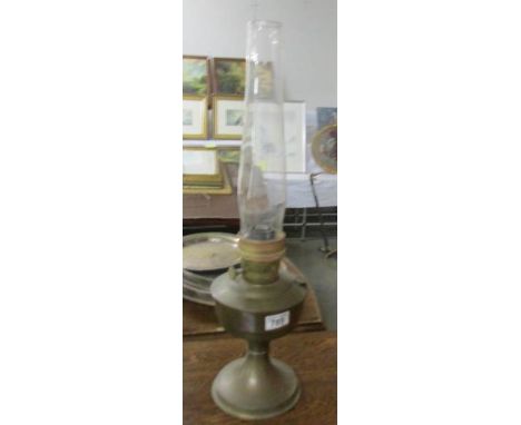 A brass oil lamp with chimney.