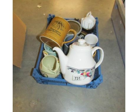 A box of assorted ceramic items including teapot, tankards etc.,