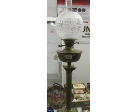 A brass Corinthian oil lamp with etched shade.