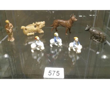 A mixed lot including 2 metal dogs, a metal figure of a lady, ceramic gnomes on pigs etc.,