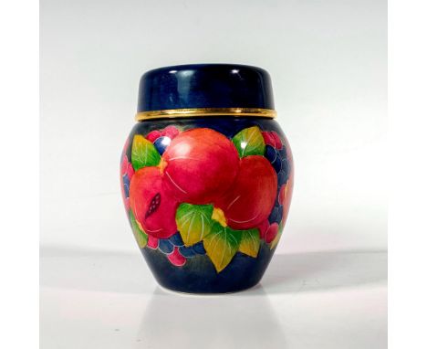 A limited edition, lidded jar adorned with pomegranate decoration on blue ground; fashioned of enamel on copper. Moorcroft ba