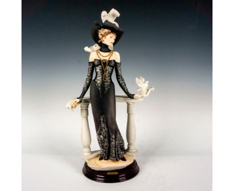 Limited edition featuring a lady standing with a bird perched next to her; standing on a round wooden base. Giuseppe Armani s