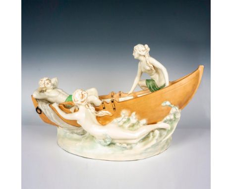 Art nouveau glazed porcelain grouping depicting a fisherman sleeping in his boat surrounded by two beautiful classical nude w