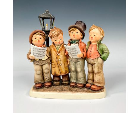 Hand painted featuring four boys dressed for winter and singing together in front of a light post. Two boys are holding sheet